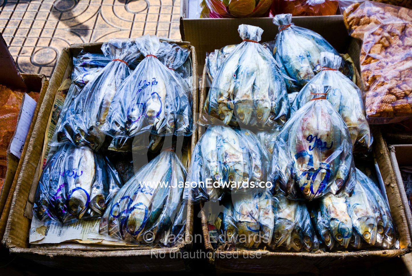 Freshly caught fish for sale in plastic bags in an open air market. Phra Nakhon District, Rattanakosin District, Bangkok, Thailand.