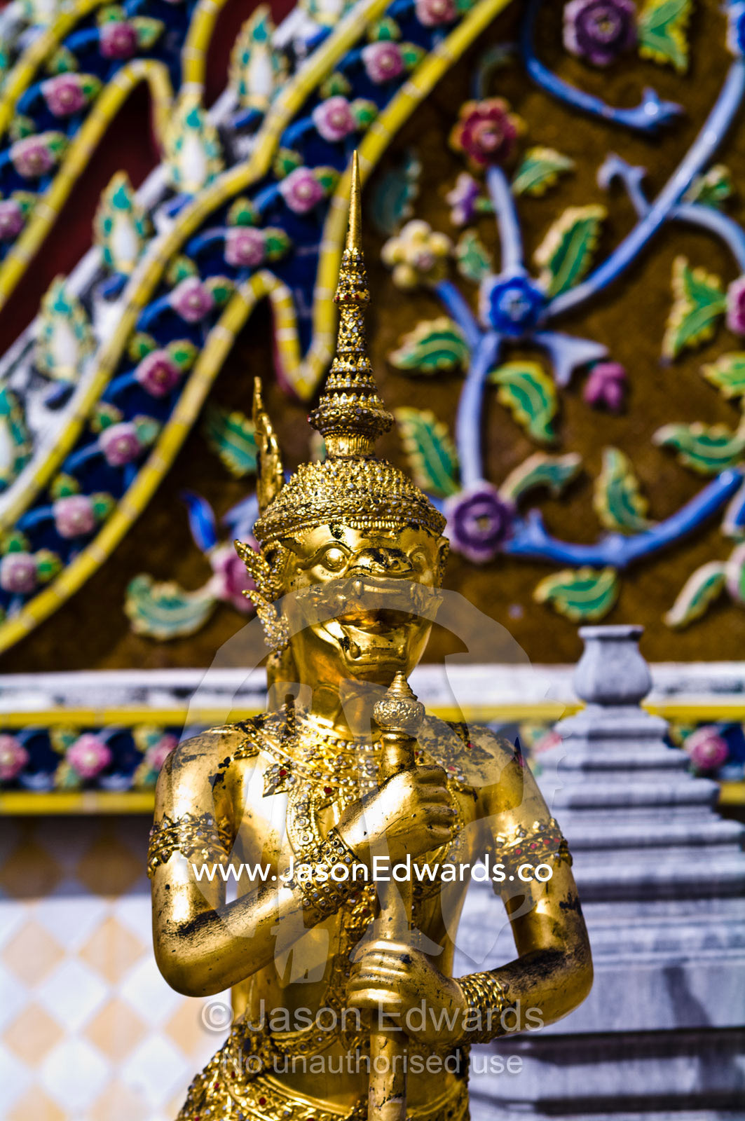 An ornate golden statue guards a Buddhist temple in Bangkok. Prasat Phra Thep Bidon, Royal Pantheon, Wat Phra Kaew, Wat Phra Kaeo, Temple of the Emerald Buddha, Bangkok, Thailand.