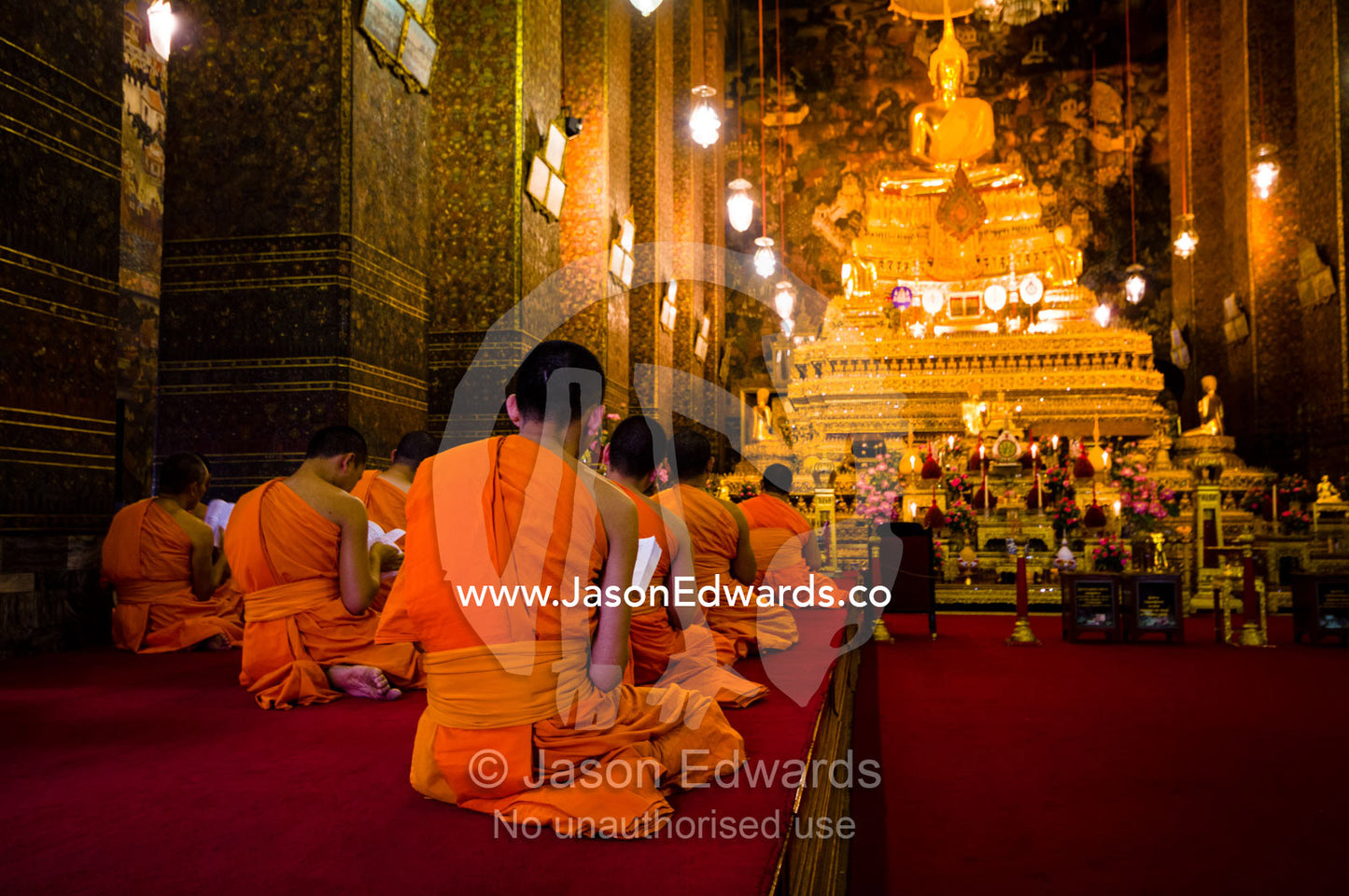 Buddhist monks in deep prayer in the Ubosot, the temple's chapel. Wat Pho, Temple of the Reclining Buddha, Wat Chetuphon, Phra Nakhon District, Rattanakosin District, Bangkok, Thailand.