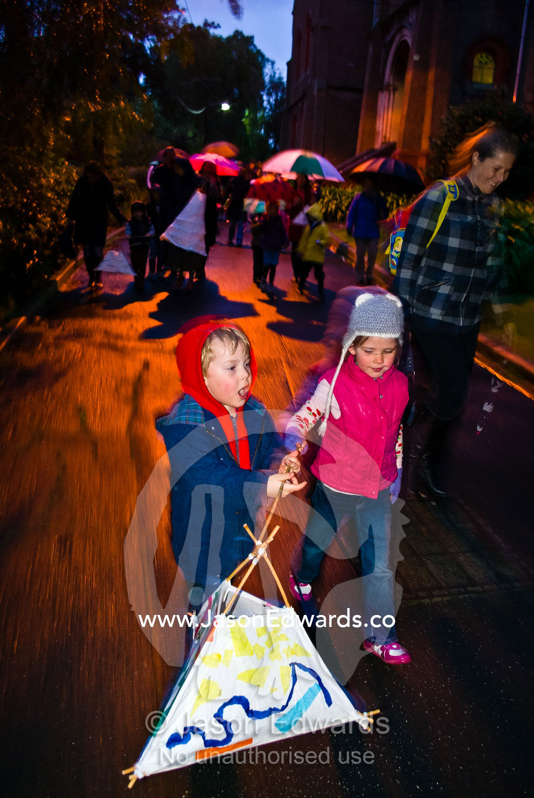 Friends carry a paper lantern on a lantern walk on a winters night. University of Melbourne, ELC Education Learning Centre, Abbotsford Convent, Abbotsford, Melbourne, Victoria, Australia.