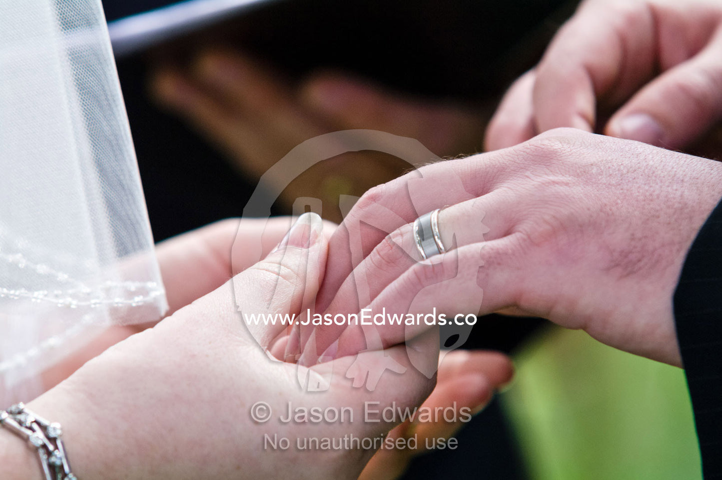 A bride and groom hold hands whilst taking their wedding vows. Park Orchards, Melbourne, Victoria, Australia.