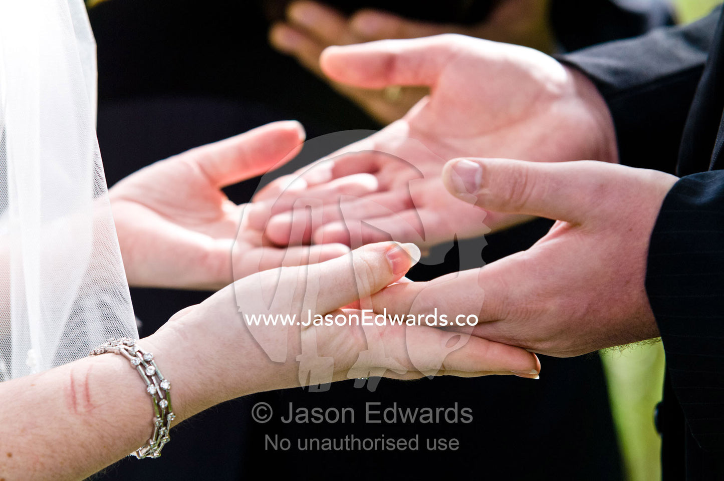 A bride and groom hold hands whilst taking their wedding vows. Park Orchards, Melbourne, Victoria, Australia.