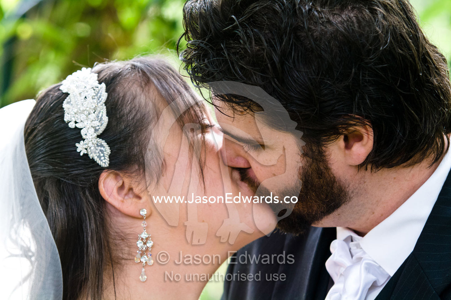 A bride and groom kissing after their vows on their wedding day. Park Orchards, Melbourne, Victoria, Australia.