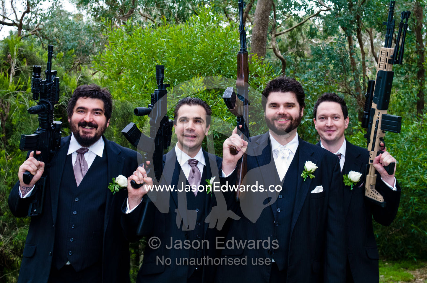 A groom and his groomsmen with their guns on his wedding day. Park Orchards, Melbourne, Victoria, Australia.