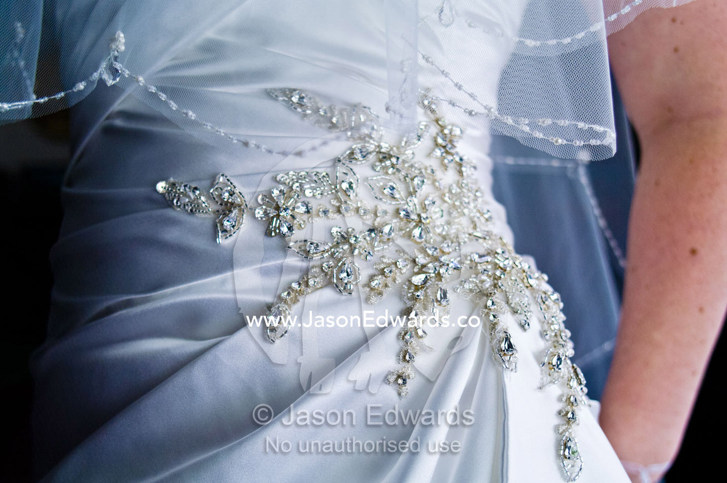 Ornate diamante applique on the gathered waist of a satin bridal gown Park Orchards, Melbourne, Victoria, Australia.