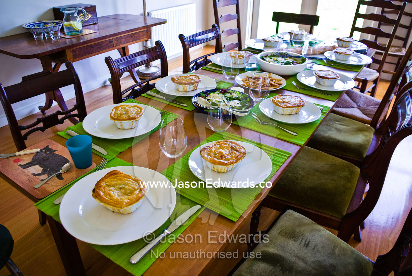 A table set for a luncheon of homemade chicken pies and salad. Malvern East, Melbourne, Victoria, Australia.