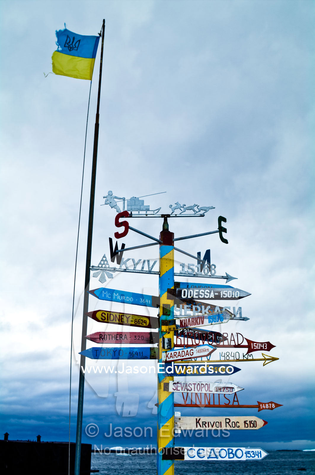 A directional sign at a Ukrainian station points to distant cities. Vernadsky Antarctic Research Base, Galindez Island, Argentine Islands, Faraday Islands, Antarctic Peninsula, Antarctica.
