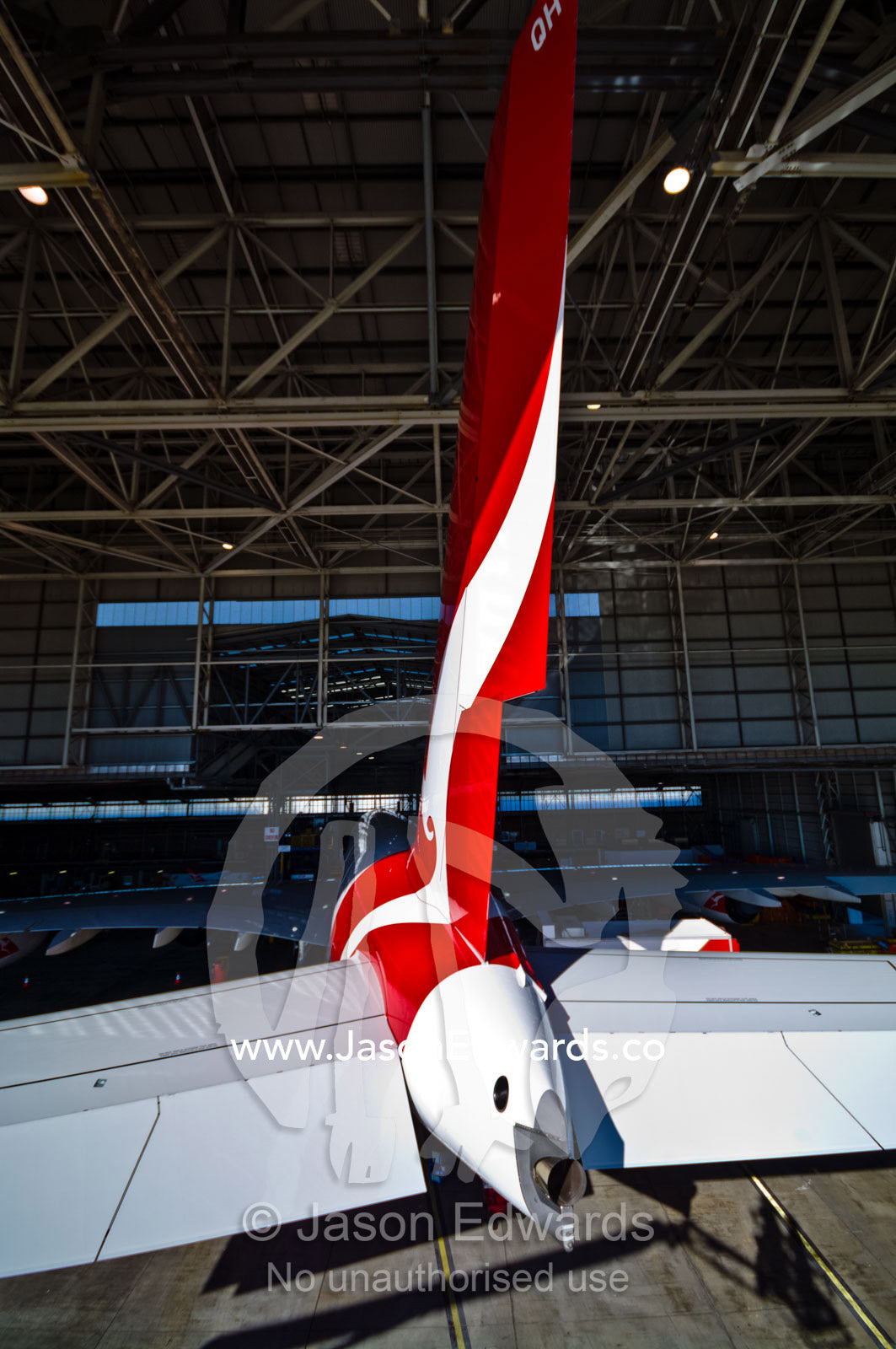The vertical stabiliser and rudder of a jet airliner in a hanger. Kingsford Smith Airport, Mascot, Sydney, New South Wales, Australia.