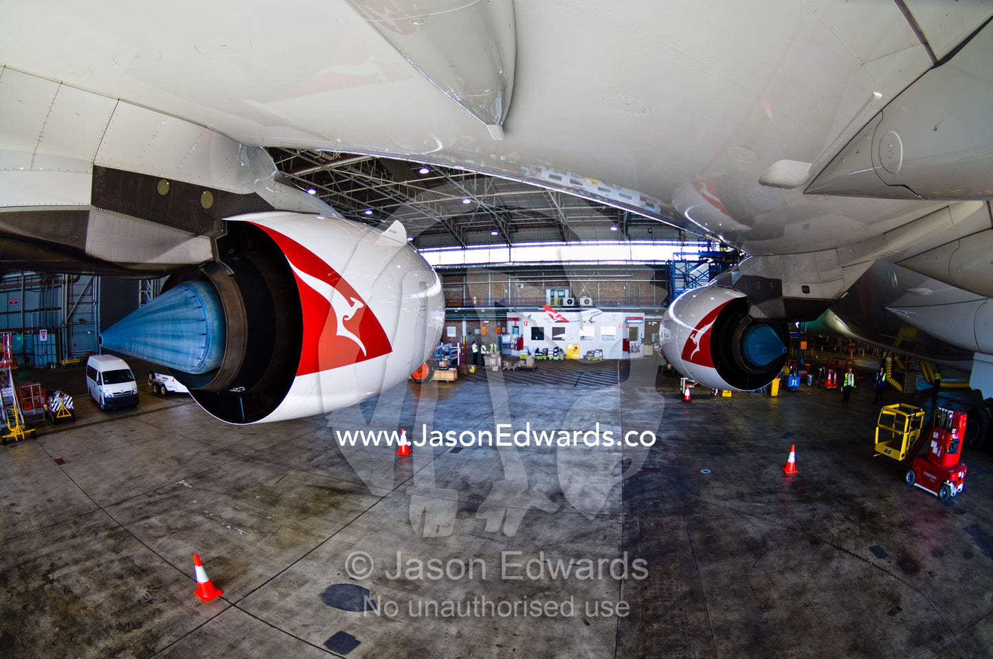Twin turbofan engines beneath the wing of a jet airliner in a hangar. Kingsford Smith Airport, Mascot, Sydney, New South Wales, Australia.