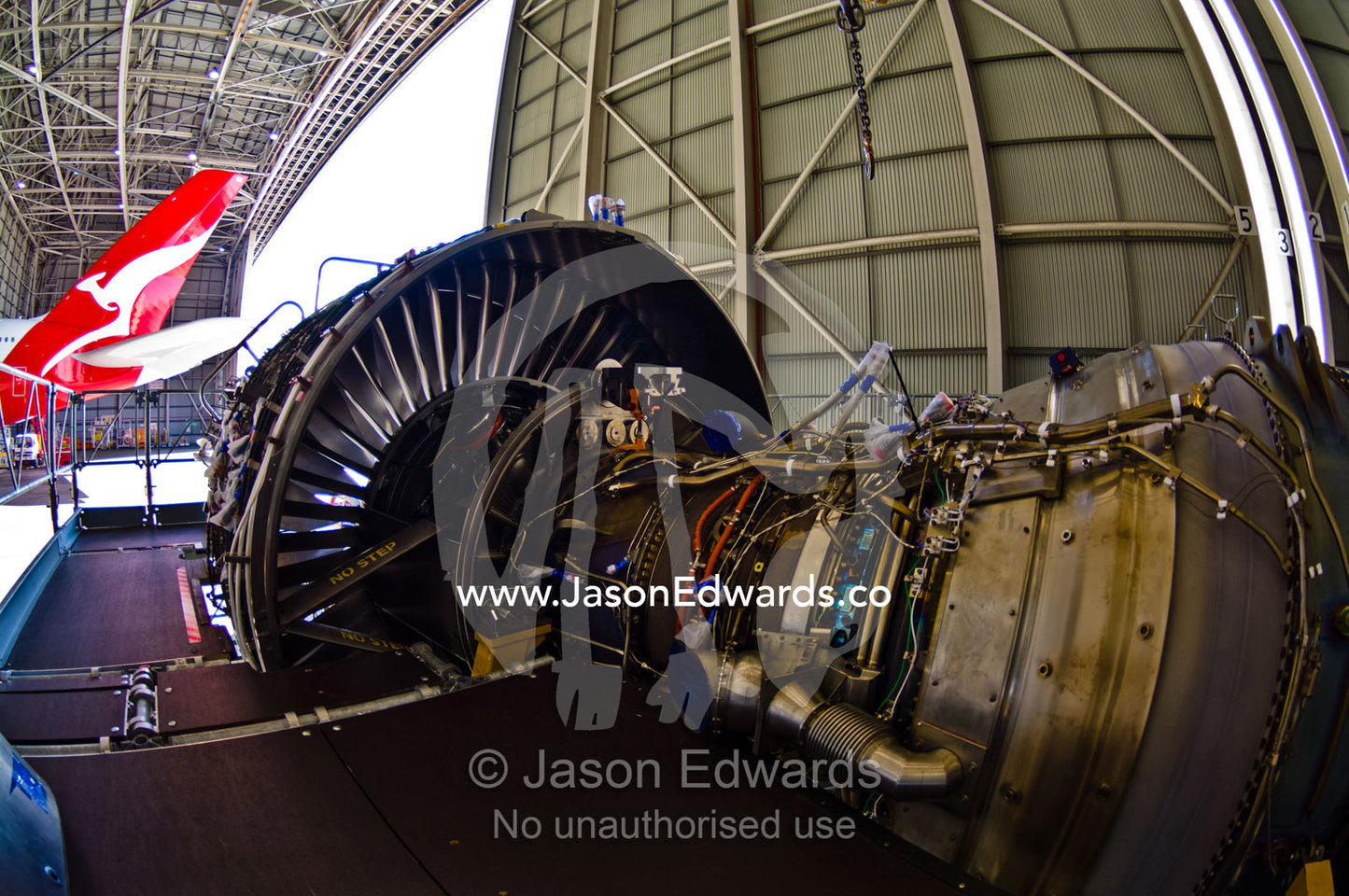 An enormous jet airliner turbofan engine being repaired in a hangar. Kingsford Smith Airport, Mascot, Sydney, New South Wales, Australia.