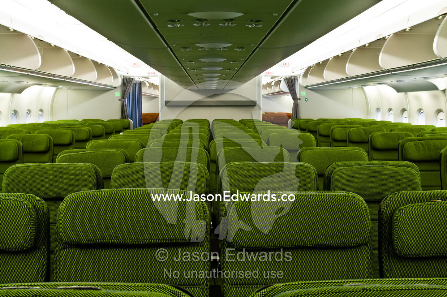 Rows of empty red economy class passenger seats in a plane cabin. Kingsford Smith Airport, Mascot, Sydney, New South Wales, Australia.