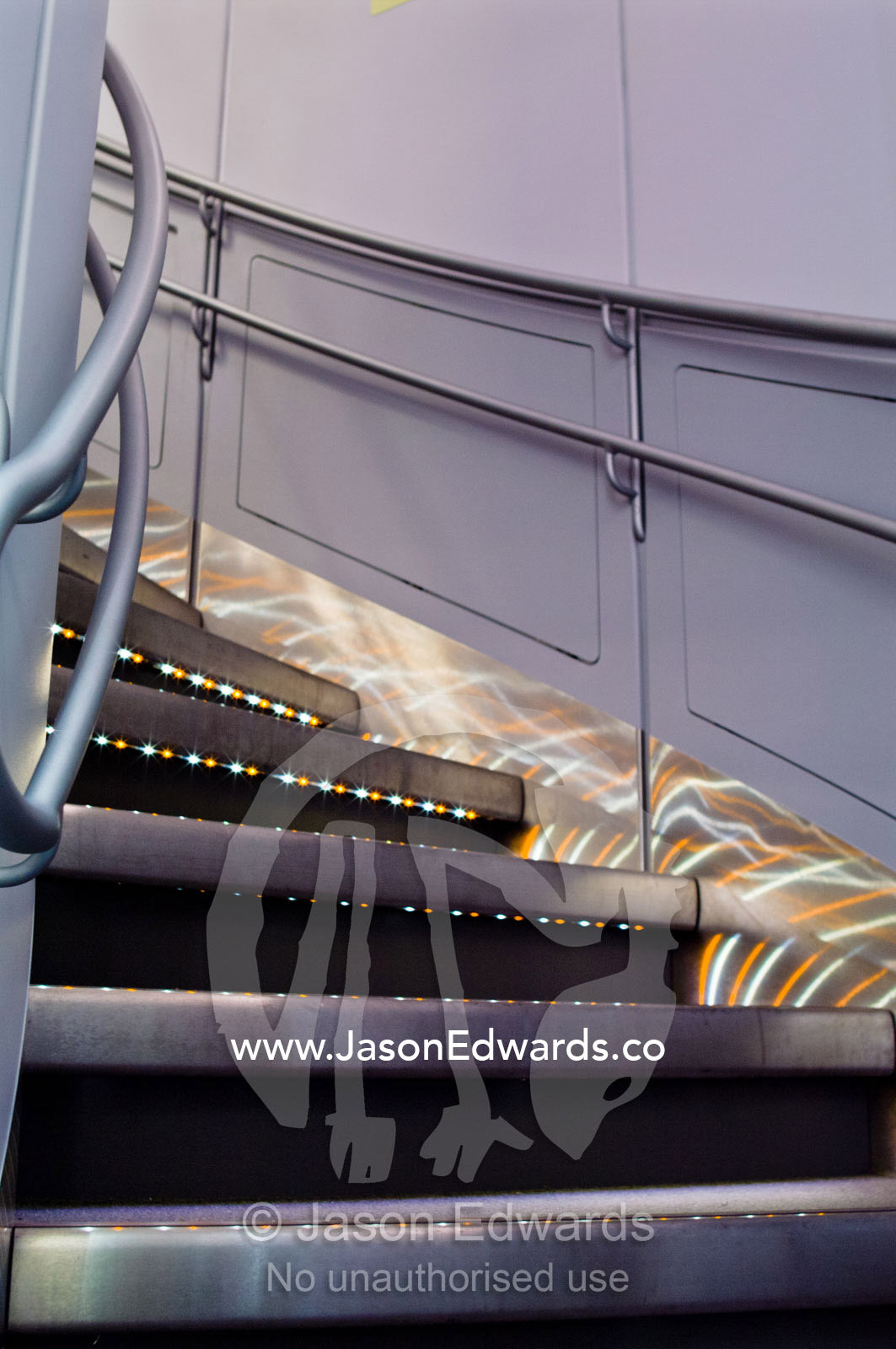 LED lighting on stainless steel steps leading to business class. Kingsford Smith Airport, Mascot, Sydney, New South Wales, Australia.
