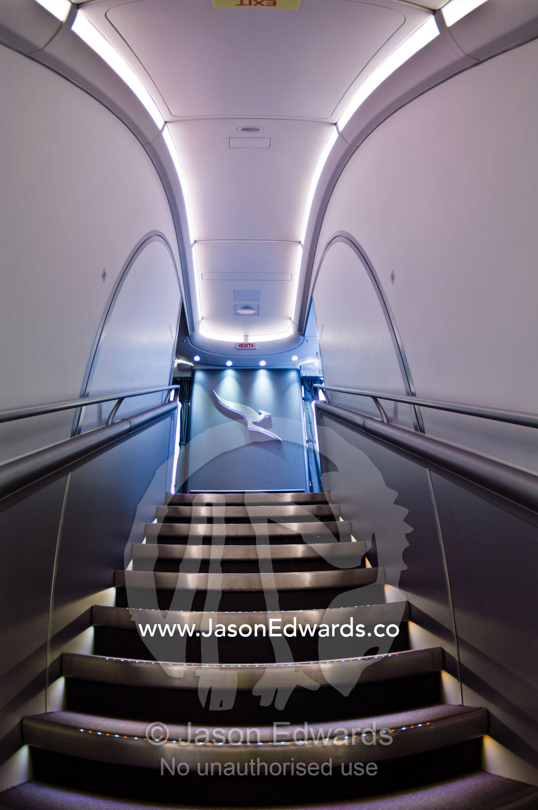 LED lighting on stainless steel steps leads to the first class cabin. Kingsford Smith Airport, Mascot, Sydney, New South Wales, Australia.