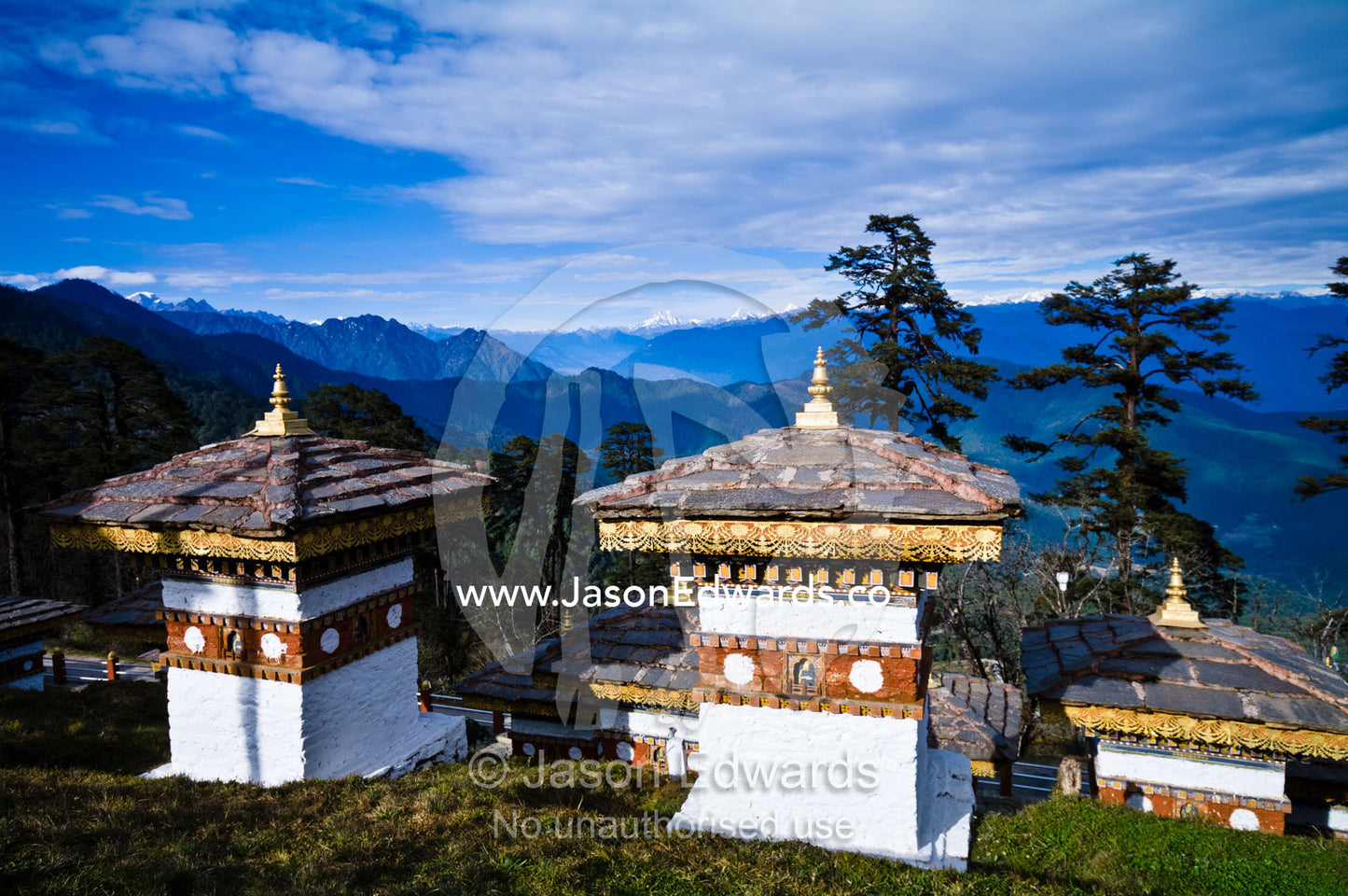A group of chortens overlook the Himalaya from a mountaintop. 108 Druk Wangyal Khangzang Chortens, Dochula Pass, Thimphu District, Bhutan.
