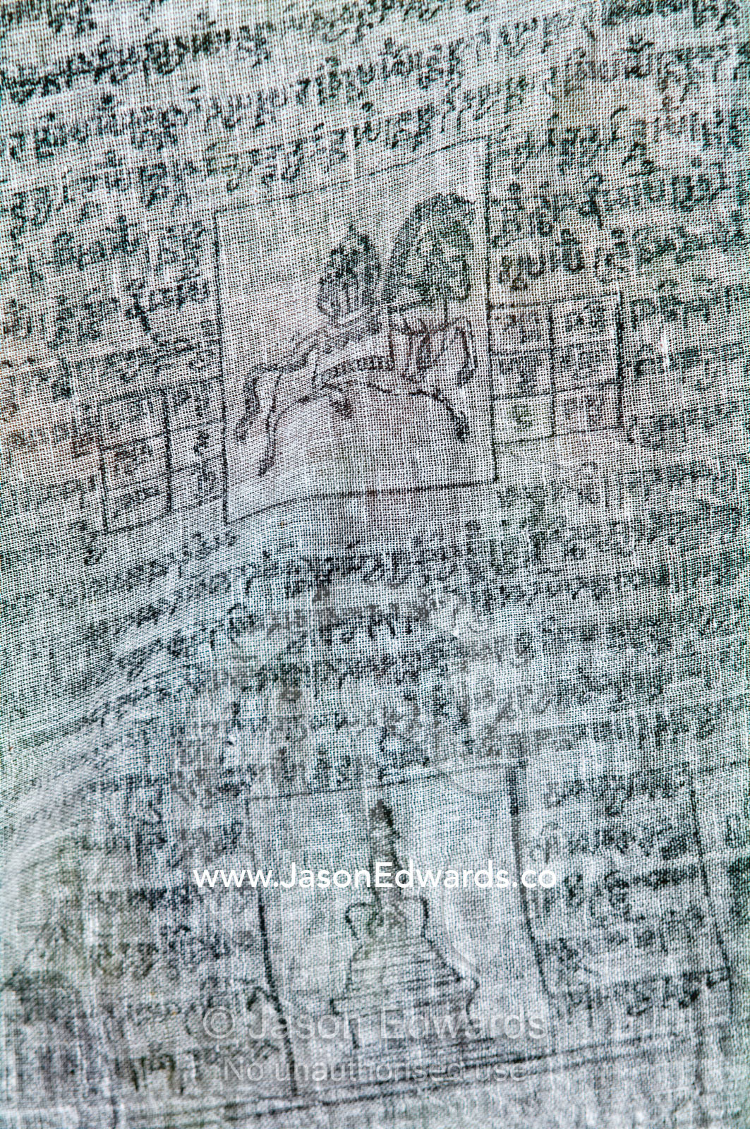 A prayer flag featuring a holy horse carrying sutras and a stupa hanging from a tree. Paro, Paro District, Bhutan.