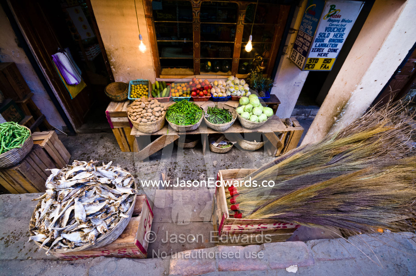 Dried fish, grass brooms and vegetables for sale at a small general store. Thimphu, Thimphu District, Bhutan.
