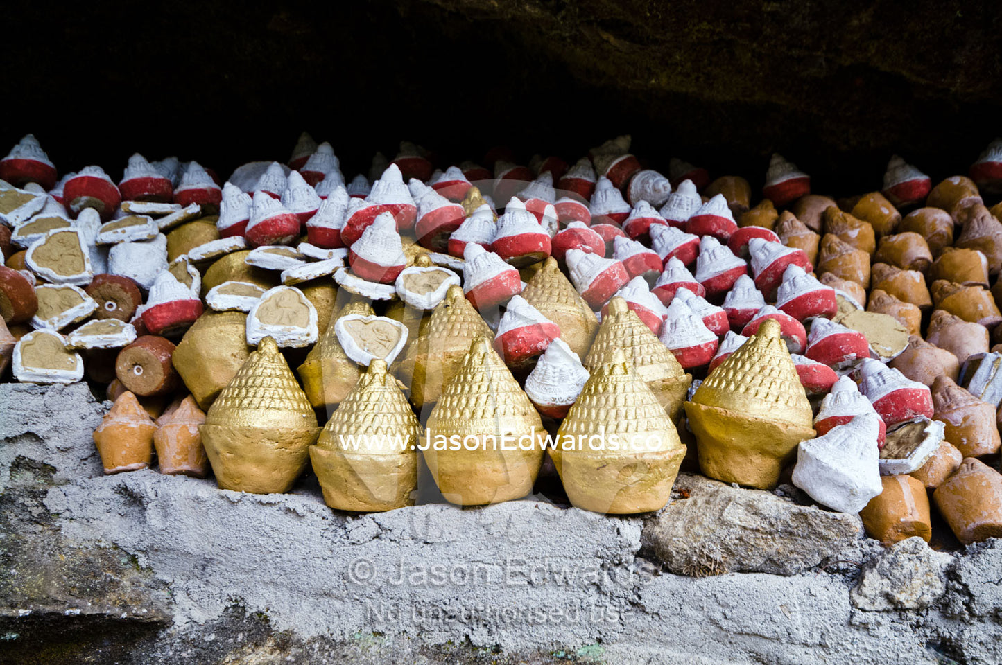 People place reliquaries or religious tsa tsa on a cliff in a Himalaya valley in memory of deceased loved ones. Dochula Pass, Thimphu District, Bhutan.