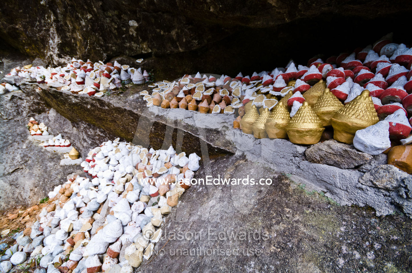 People place reliquaries or religious tsa tsa on a cliff in a Himalaya valley in memory of deceased loved ones. Dochula Pass, Thimphu District, Bhutan.