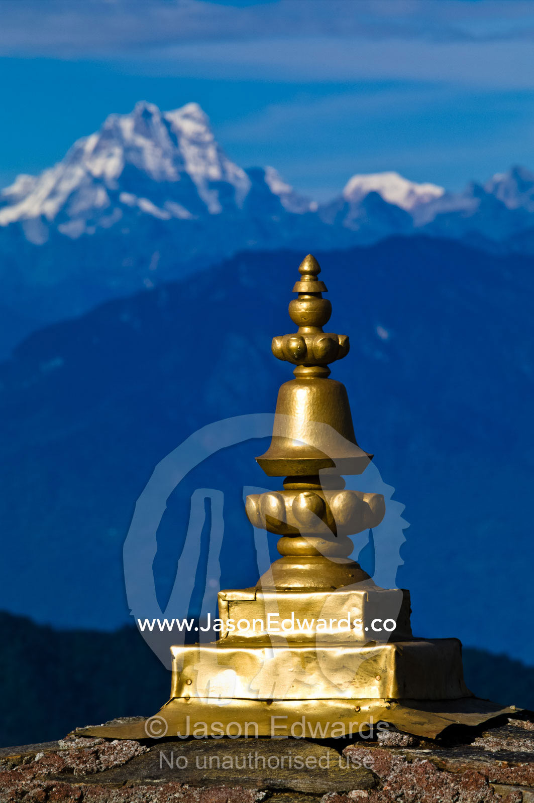 The golden cupola spire on a chorten faces the snowy Himalaya peaks. 108 Druk Wangyal Khangzang Chortens, Dochula Pass, Thimphu District, Bhutan.