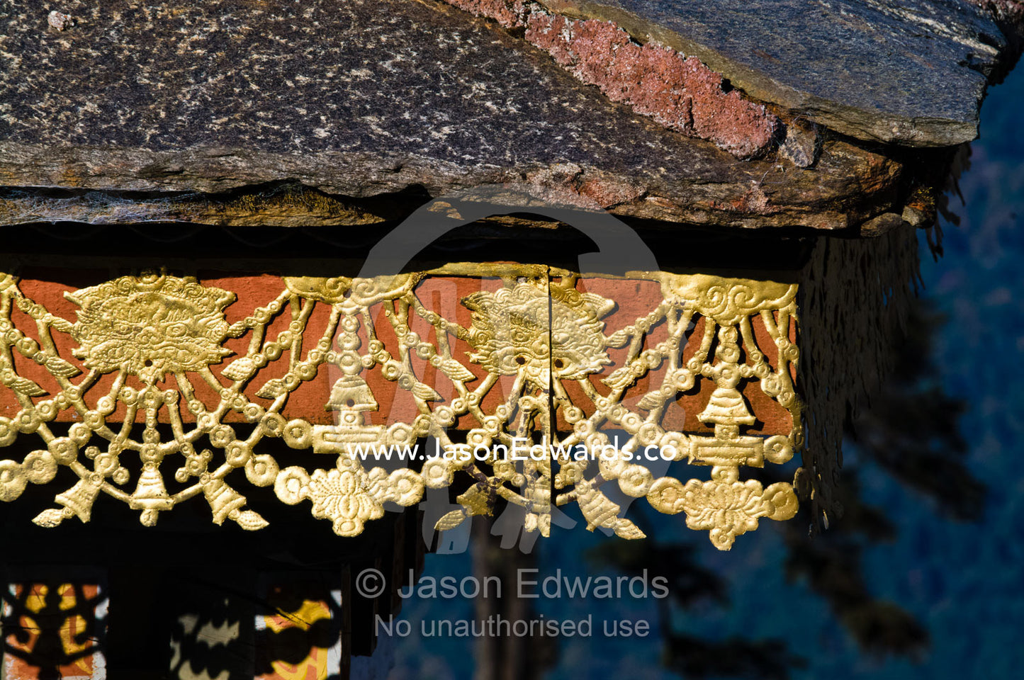 The tiled roof and ornamental eave of a chorten in the Himalaya. 108 Druk Wangyal Khangzang Chortens, Dochula Pass, Thimphu District, Bhutan.