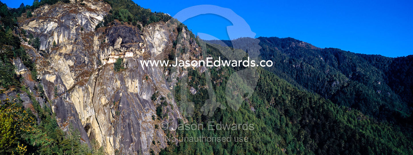 An ancient Buddhist monastery clinging to a sheer cliff on a Himalaya mountainside. Paro Taktsang, The Tigers Nest, Paro Valley, Paro District, Bhutan.