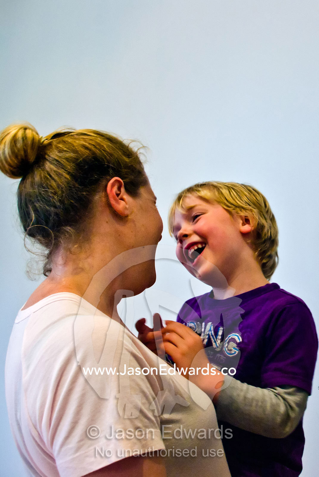 A mother and son looking at each other lovingly and laughing. Carlton North, Melbourne, Victoria, Australia.