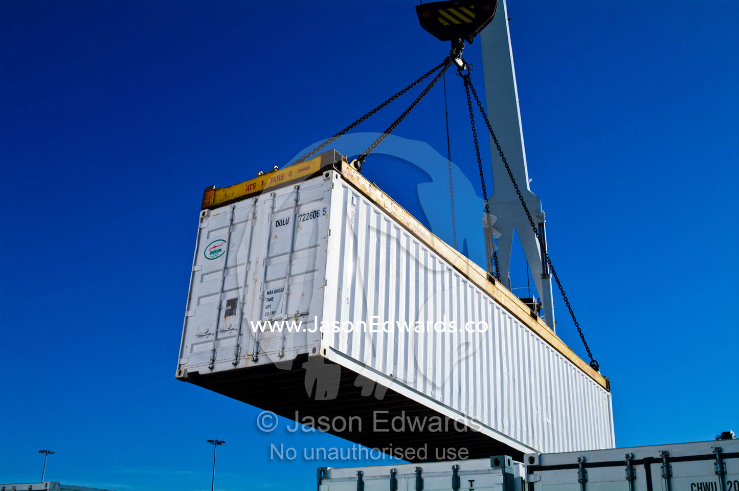 A crane lifts a shipping container from the cargo hold of a ship. Appleton Dock, Port of Melbourne, West Melbourne, Victoria, Australia.