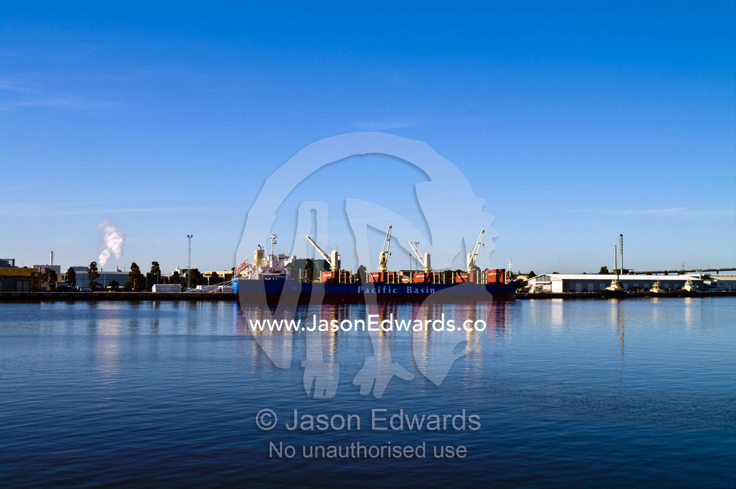 A cargo ship at a dock to be loaded with with shipping containers. Yarra River, Appleton Dock, Port of Melbourne, West Melbourne, Victoria, Australia.