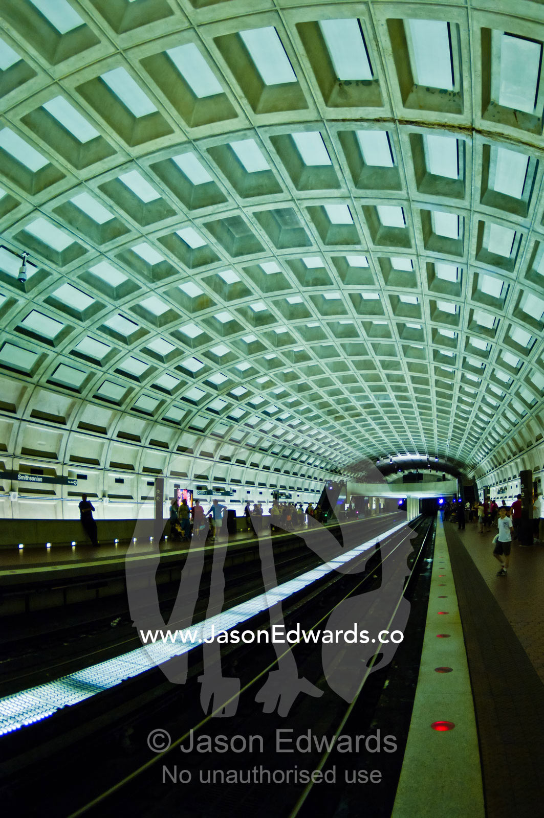 Passengers wait on a subway platform in Washington DC. Washington, District of Columbia, United States of America.