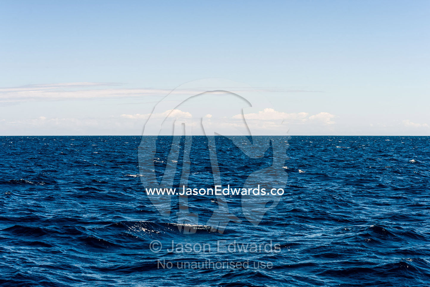 A calm ocean surface stretching all the way to the horizon. Exmouth, Ningaloo Reef, Ningaloo Marine Park, World Heritage Site, Western Australia, Australia.