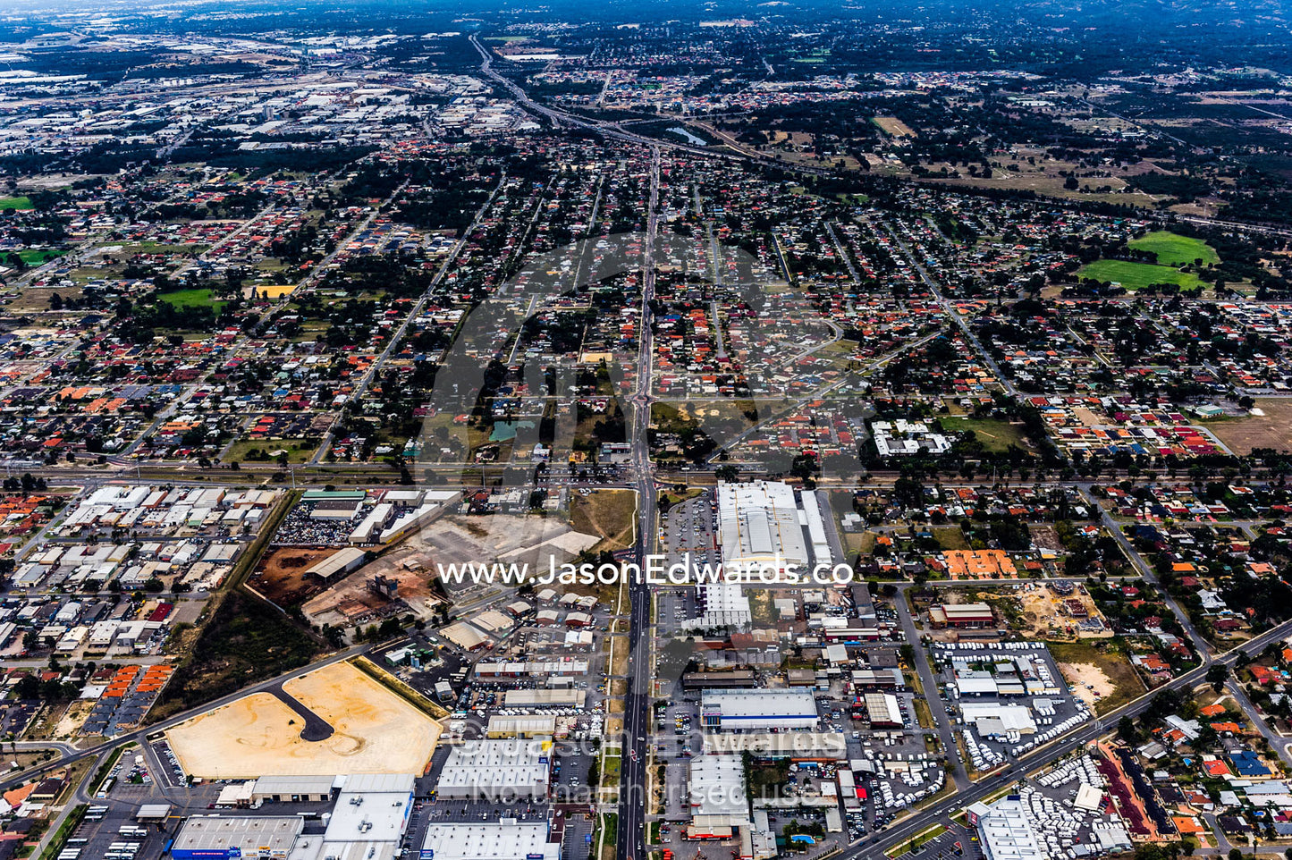 A factory and industrial precinct next to suburban housing sprawl. Perth, Western Australia, Australia.