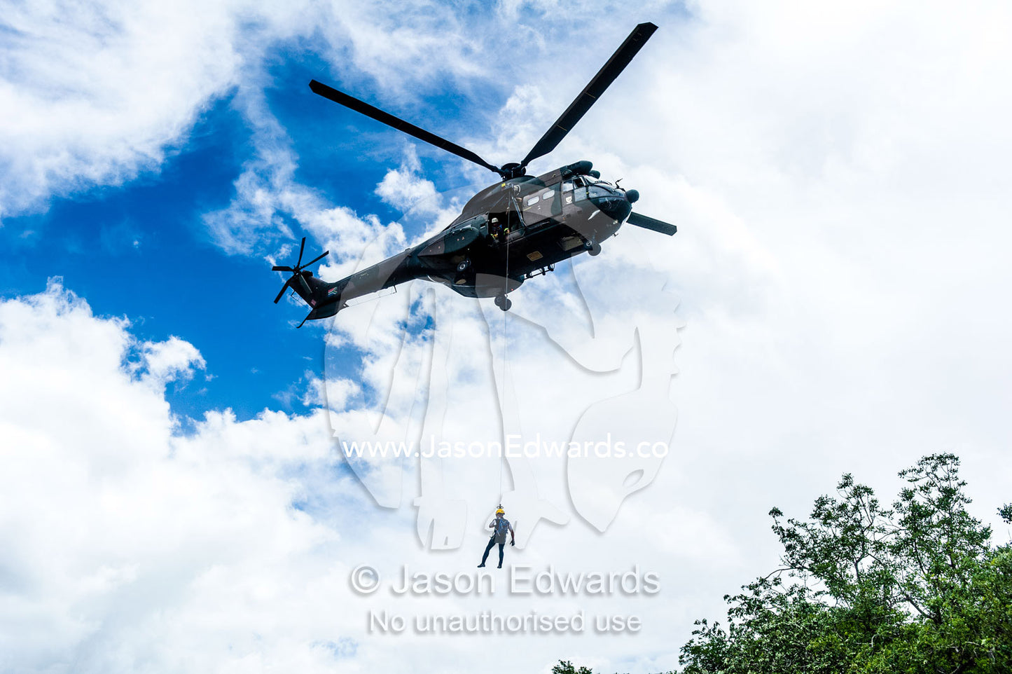 Airforce and police rescue crew lowered from an Atlas Oryx helicopter. Kruger National Park, South Africa.