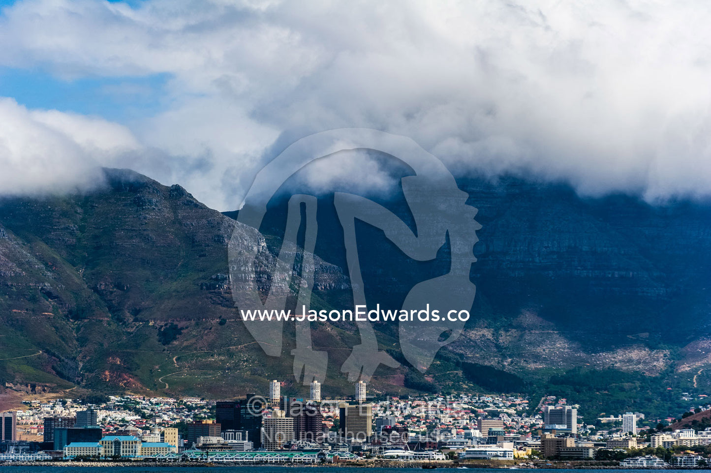 Cape Town in the cloud covered shadow of Table Mountain. Table Mountain, Cape Town, Cape Peninsula, Western Cape, South Africa.