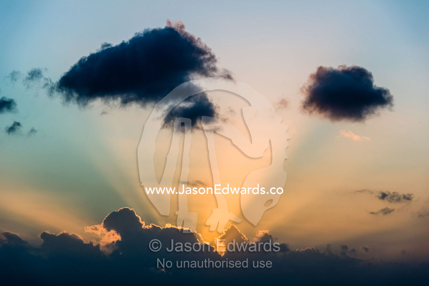 Sun rays piercing a pastel storm cloud at sunset. Clifton Beach, Cape Town, Western Cape, South Africa.