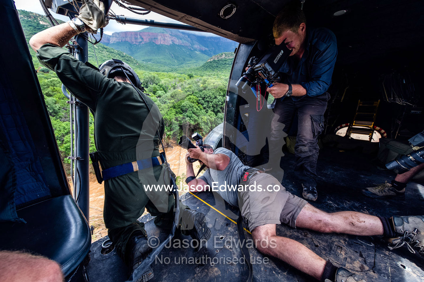 Photographer and cameraman film an airforce rescue crew in a flood. Kruger National Park, South Africa.