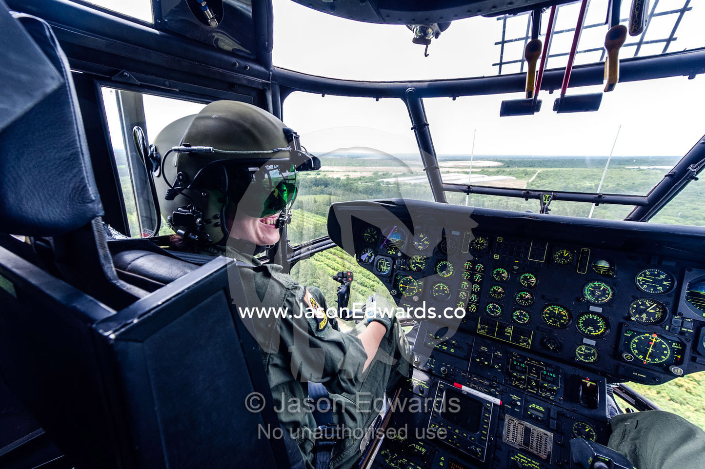 An Atlas Oryx helicopter pilot at the flight controls in the cockpit. Kruger National Park, South Africa.