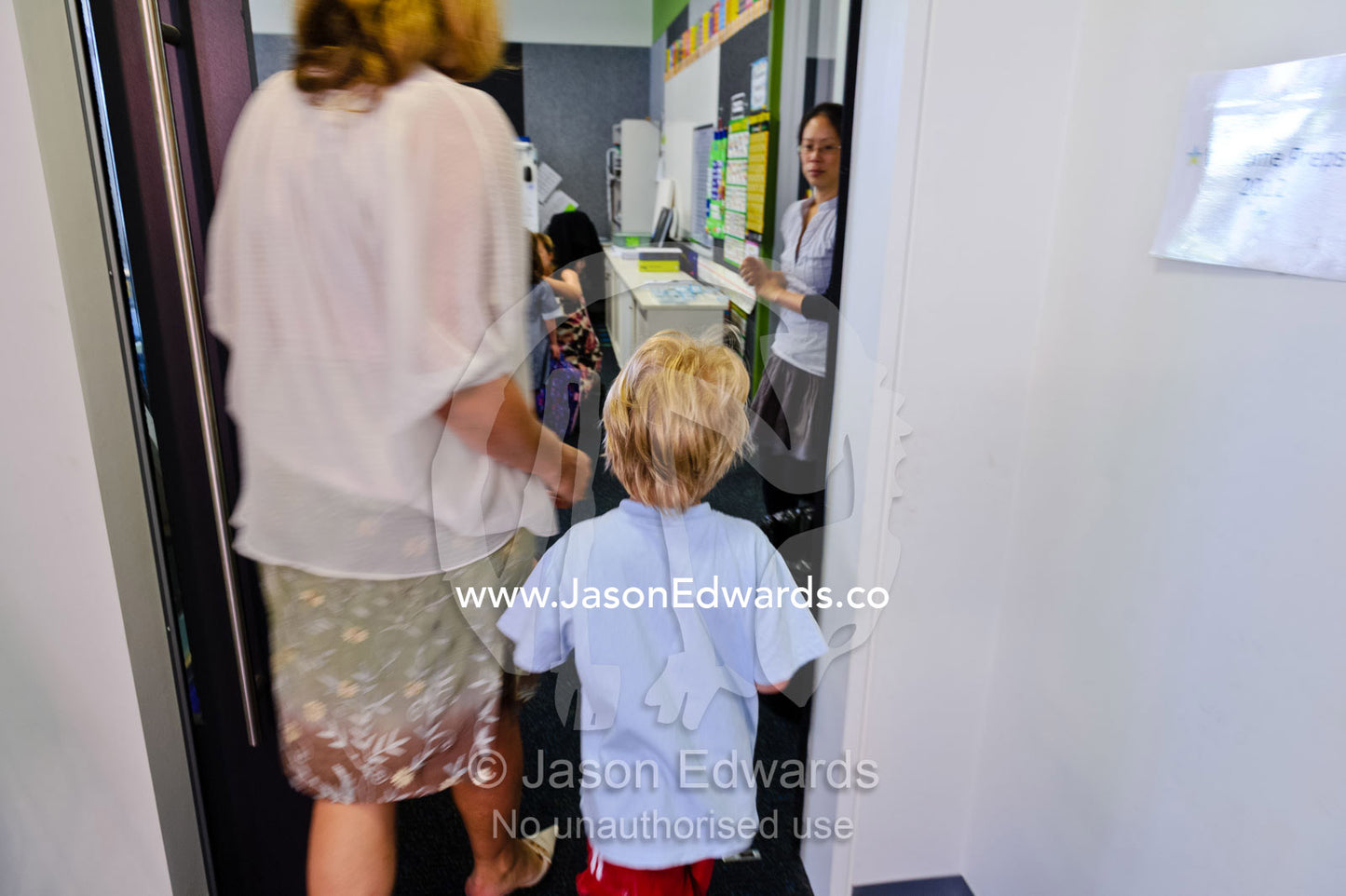 A mother walks her son to the classroom on his first day of school. Melbourne, Carlton North, Melbourne, Victoria, Australia.