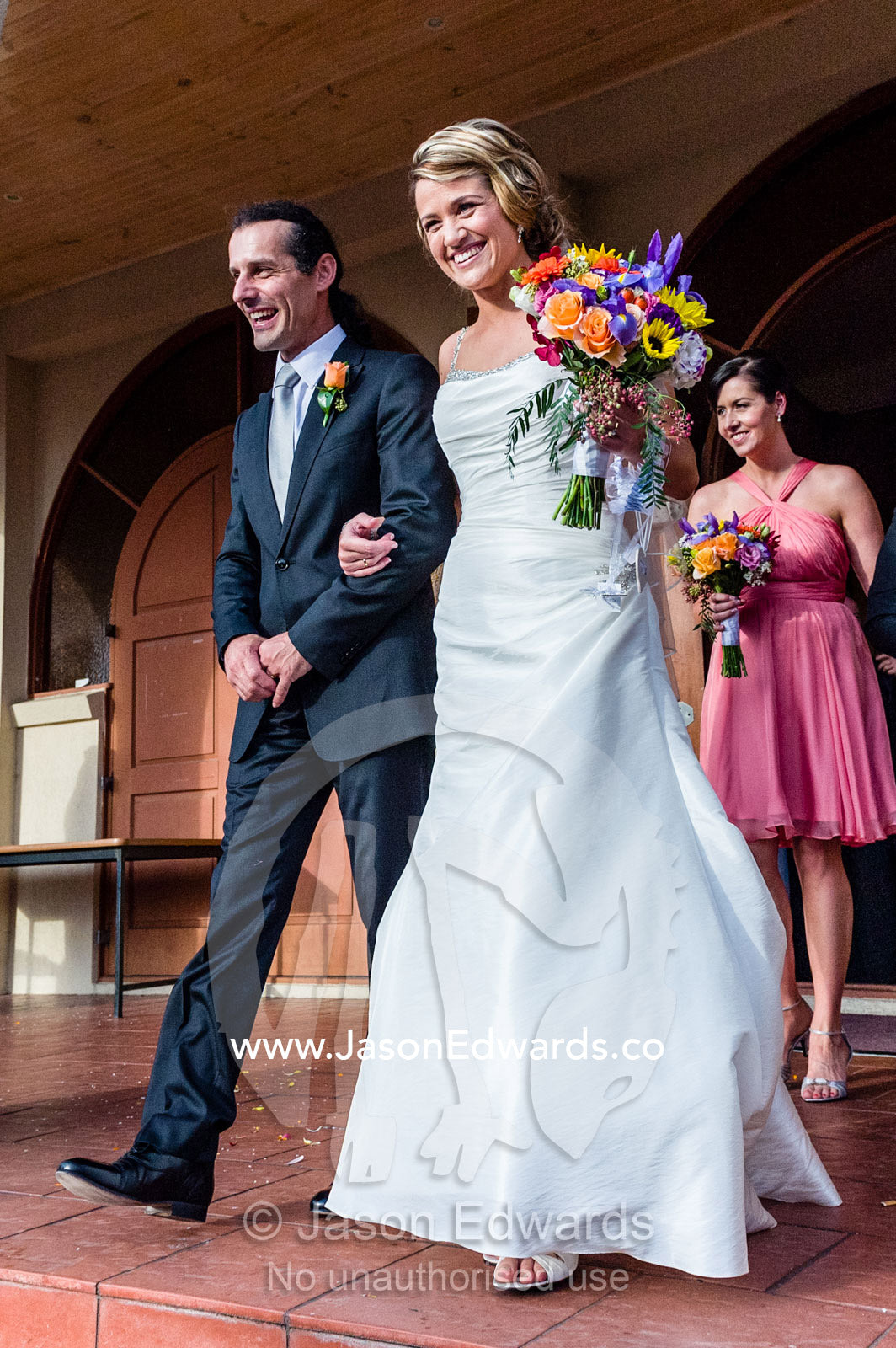 A bride and groom leave the church following a Greek Orthodox wedding. Melbourne, Victoria, Australia.