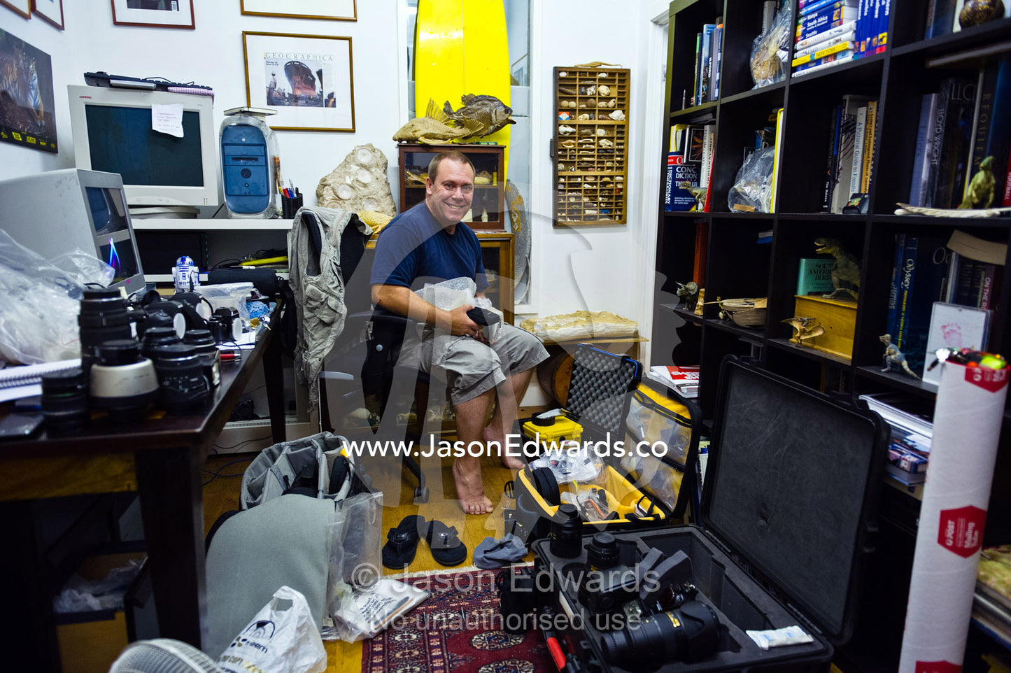 A photographer prepares his equipment for a field assignment. Collingwood, Melbourne, Victoria, Australia.