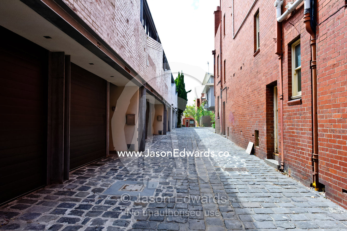 A blue-stone cobbled lane behind inner city warehouses and townhouses. Melbourne , North Melbourne , Victoria , Australia