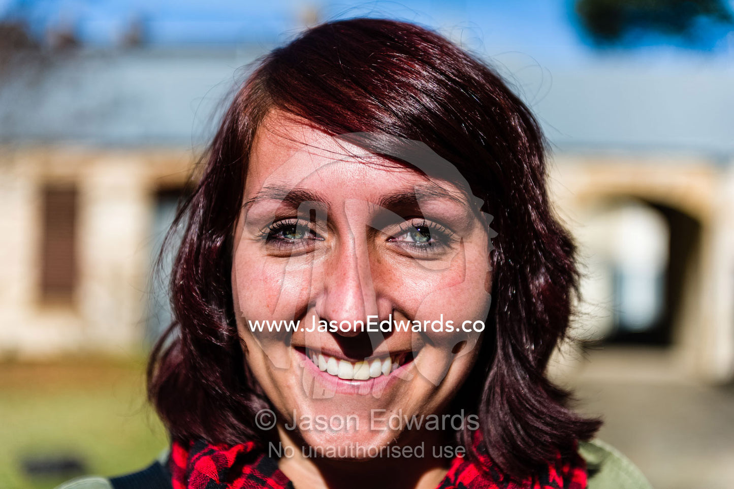 A healthy happy young woman on a clear Autumn day. The Sydney Mint, Sydney, New South Wales, Australia.