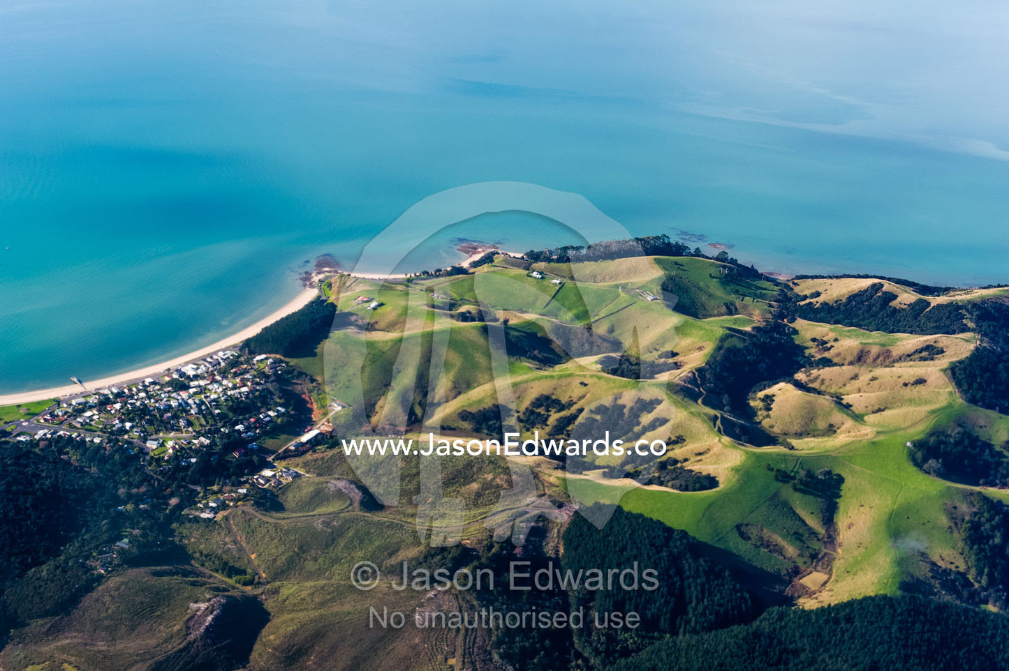 A tiny coastal town surrounded by farmland and rolling hills. Auckland, New Zealand.