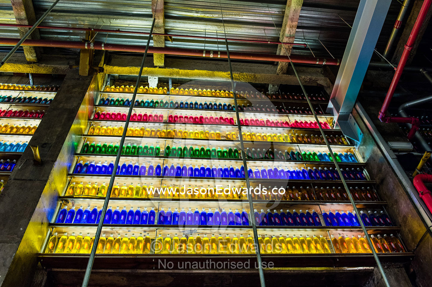 Backlit colorful bottles decorate a wall in a bar in a shopping mall. Menlyn Park, Pretoria, Menlyn Mall, Pretoria, Gauteng Province, South Africa.