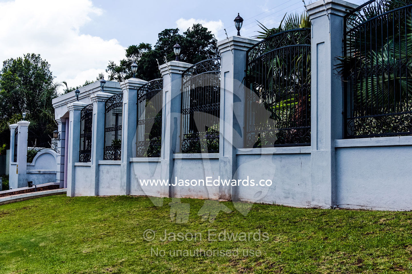 A high security fence and wall protects a home in an affluent suburb. Waterkloof, Pretoria, Gauteng Province, South Africa.