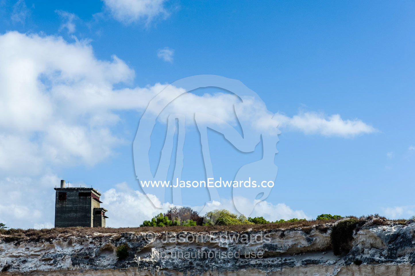 An ominous concrete guard watch tower overlooks a prison limestone quarry. Robben Island, Cape Town, Bloubergstrand, Table Bay, Western Cape, South Africa.
