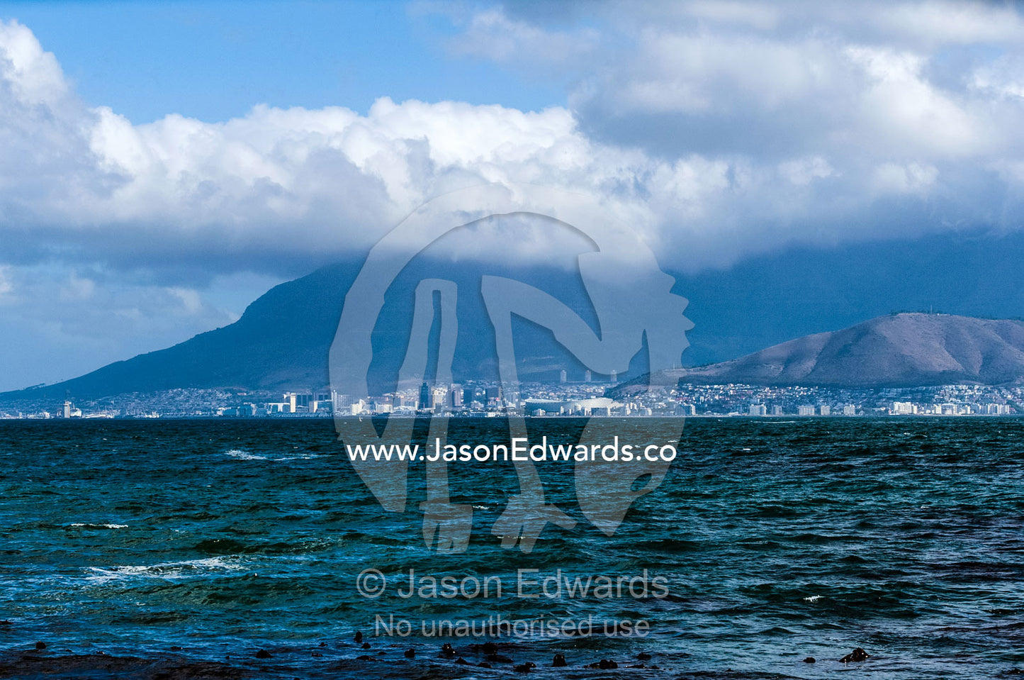 The city and suburbs of Cape Town across the Table Bay sea channel. Robben Island, Cape Town, Bloubergstrand, Table Bay, Western Cape, South Africa.