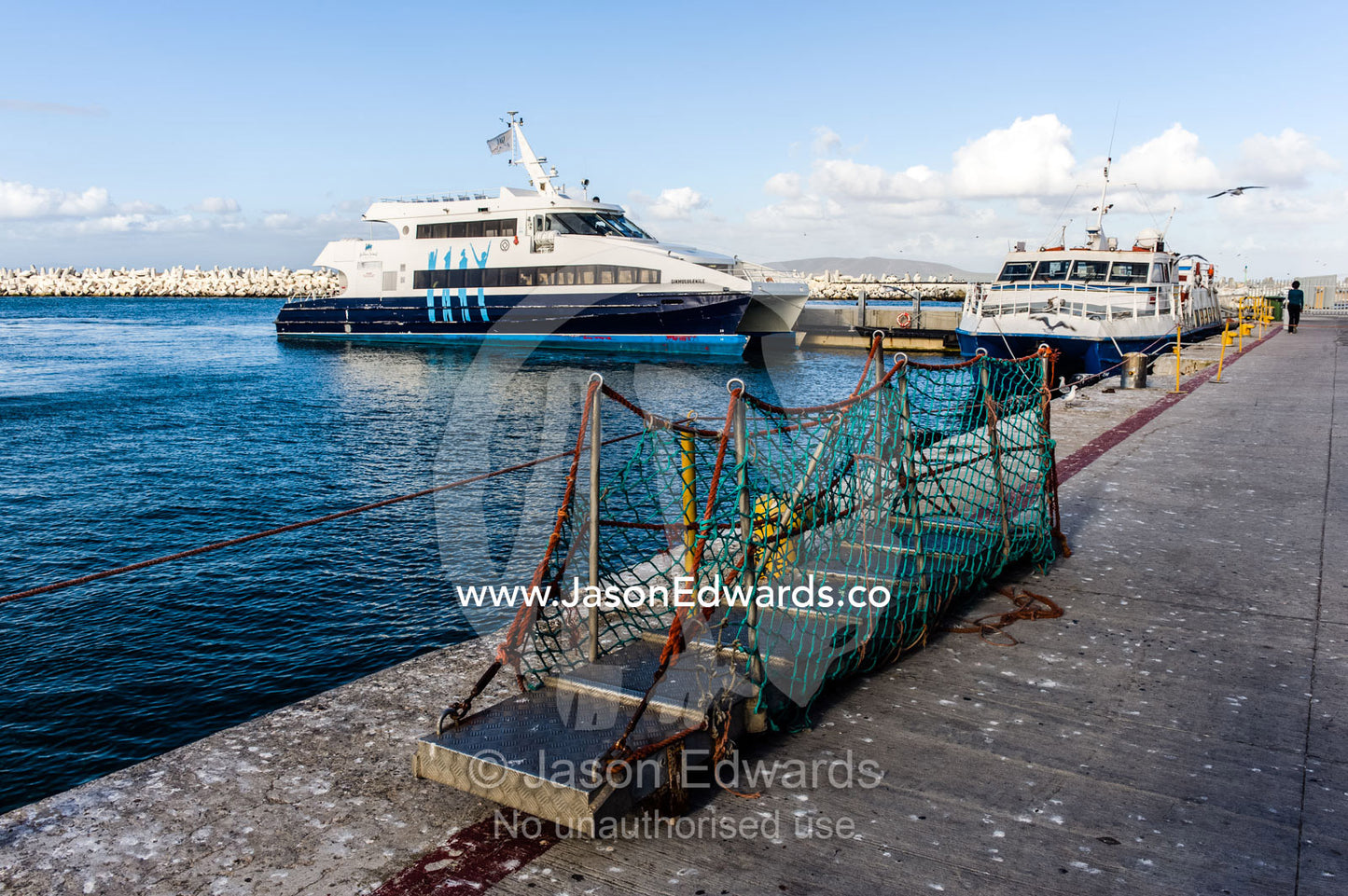 A gangplank rests on a ferry wharf waiting for disembarkation. Robben Island, Cape Town, Bloubergstrand, Table Bay, Western Cape, South Africa.