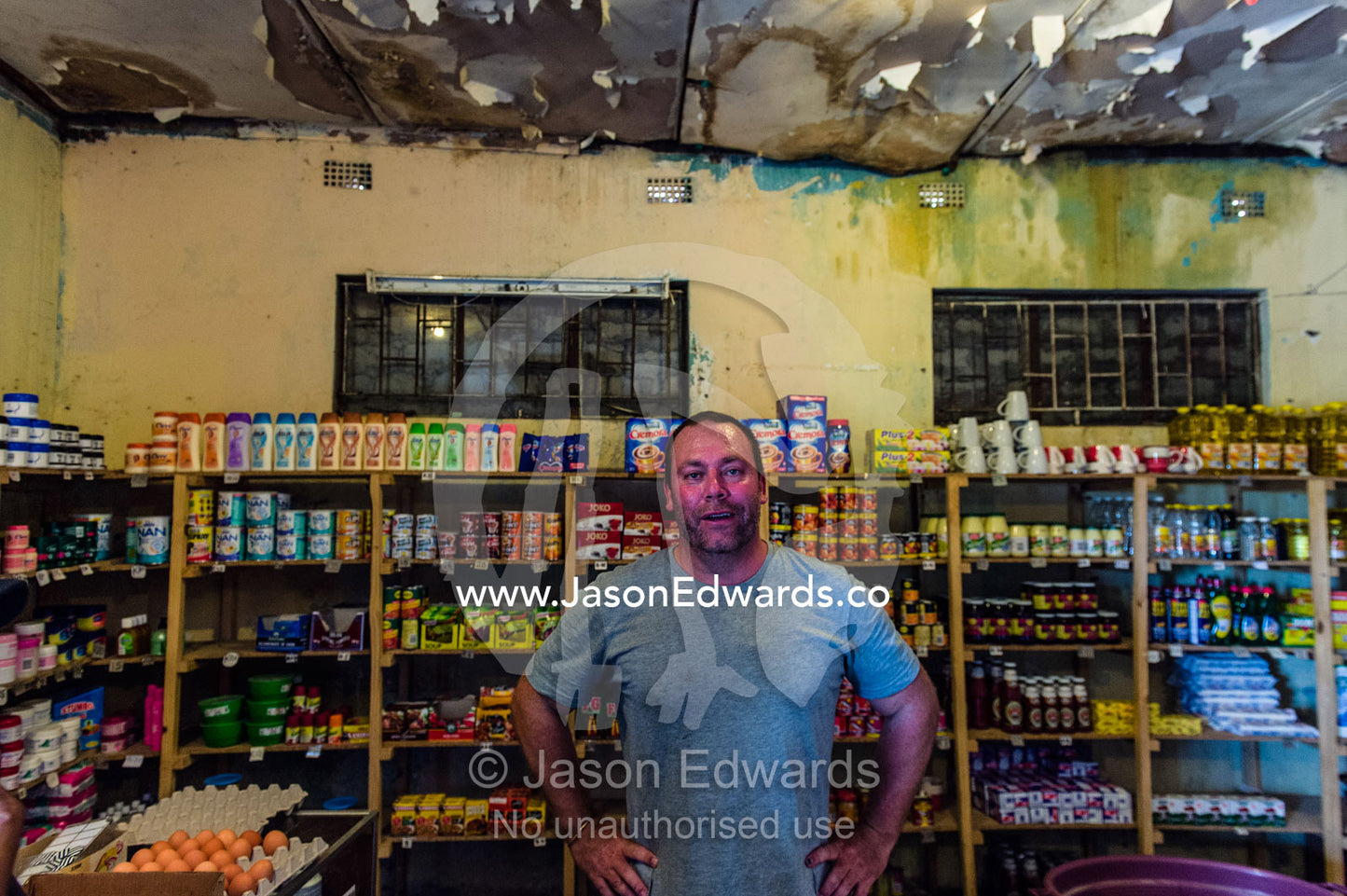 A man shopping in a small African general store. Kruger National Park, Manyeleti, Shalati Village, Mnisi Community, Limpopo, South Africa.