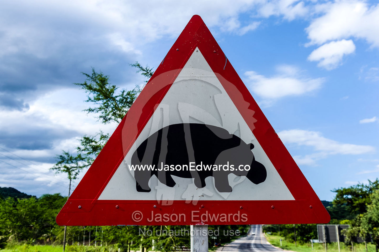 A sign warns motorists of Nile Hippopotamus crossing the road. Hazyview, Mpumalanga, South Africa.