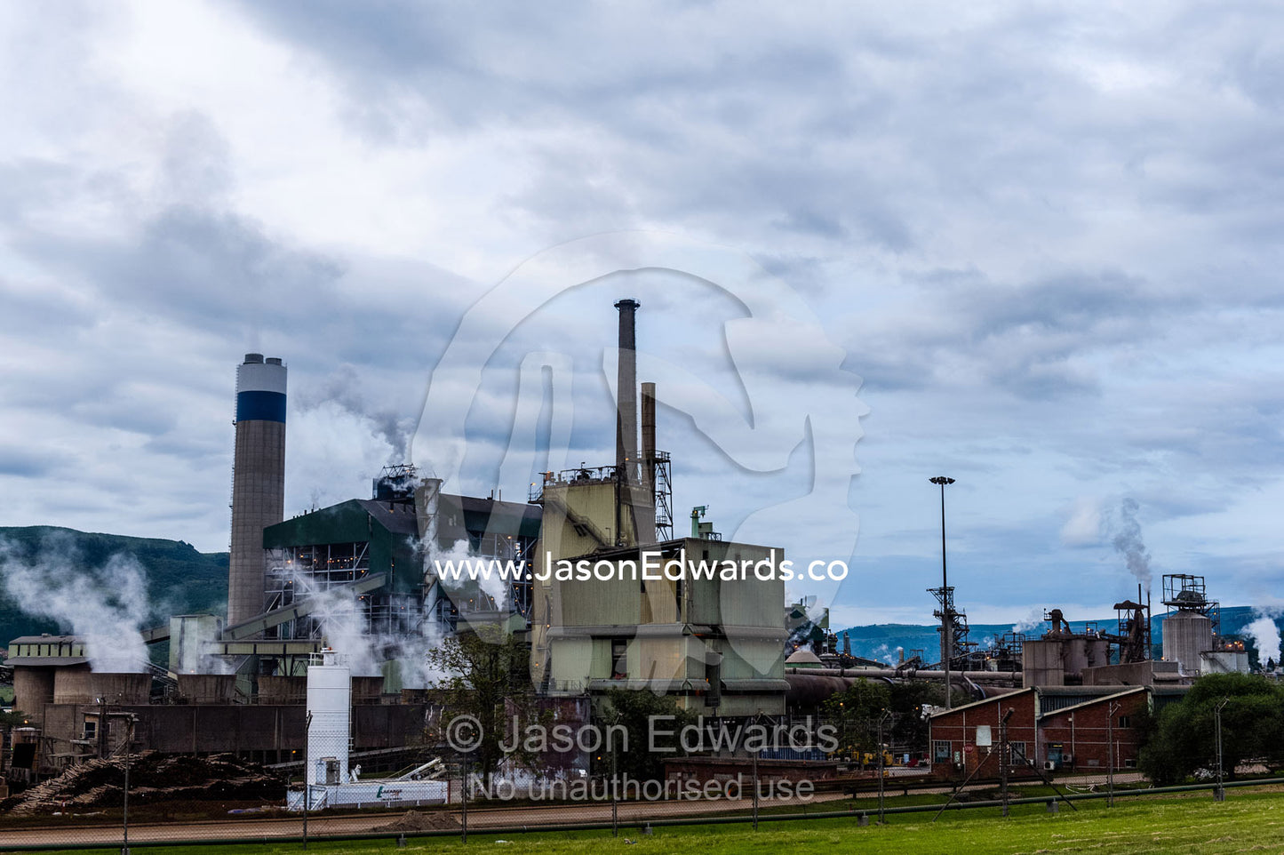 Smoke and steam pollution belch from chimneys in a paper mill. Sappi's Ngodwana Mill, Nelspruit, Mpumalanga Province, South Africa.